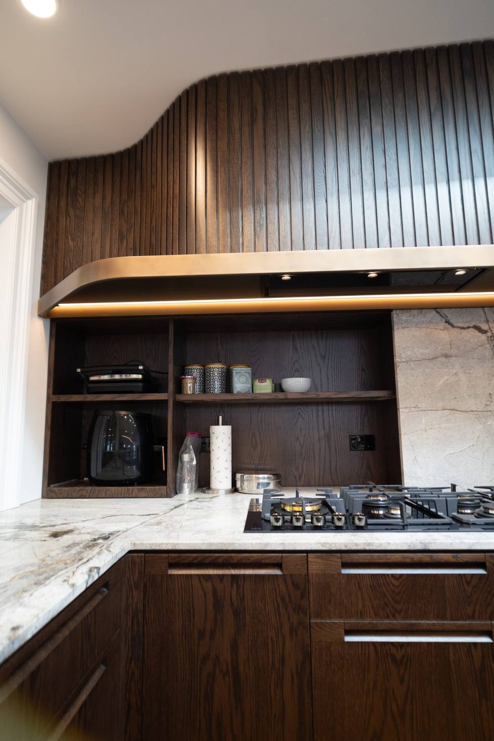 Finished kitchen renovation with timber battens and marble