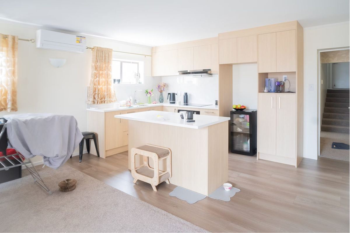 Open-plan kitchen with island in the downstairs home