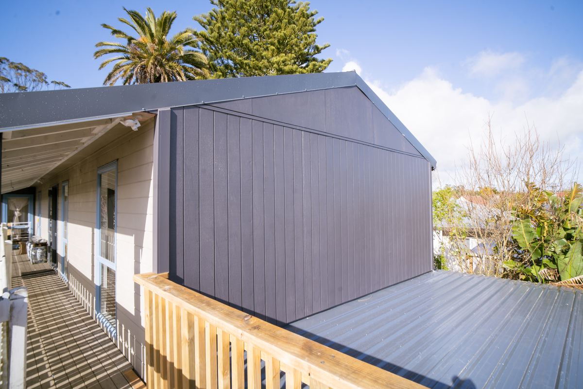 The rotten end wall reclad, with the new roof and deck balustrade