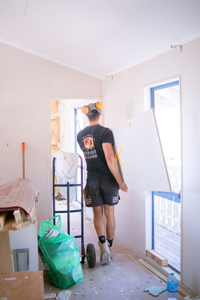 Builder barrowing old linings out during a strip-out