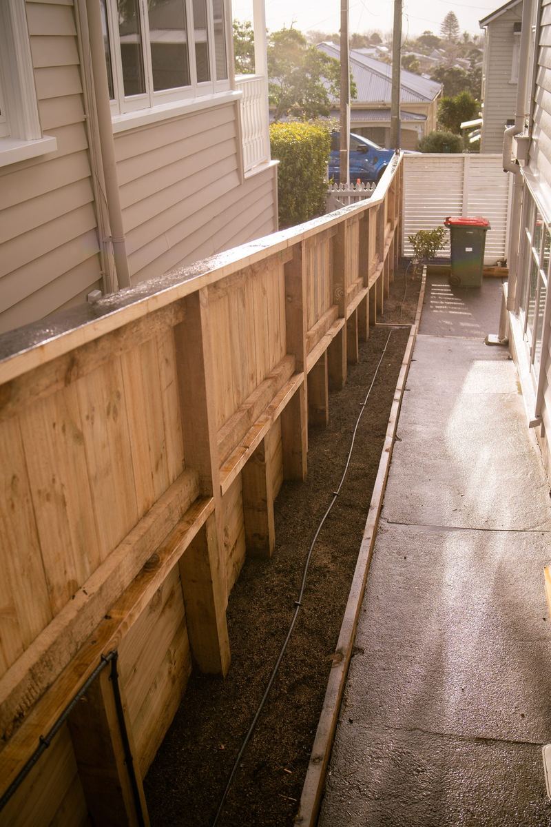 Retaining wall and fence running beside a driveway