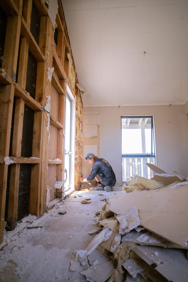 Crew stripping out a room back to the framing