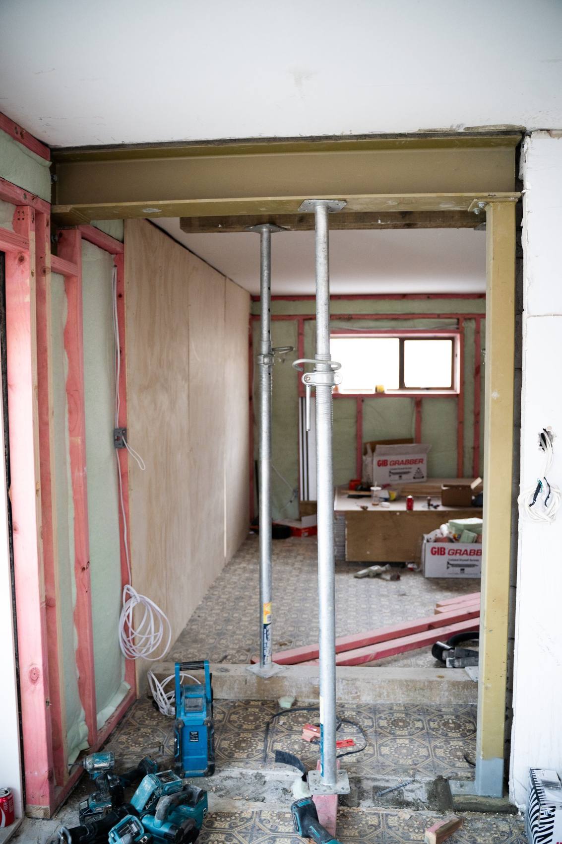 A renovation mid strip-out, with steel props holding up a new beam